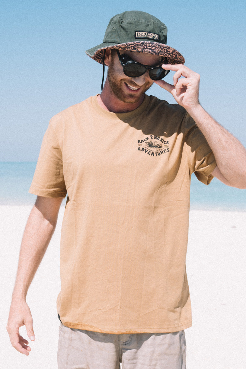 strick wearing the back 2 basics tee in rust while going fishing