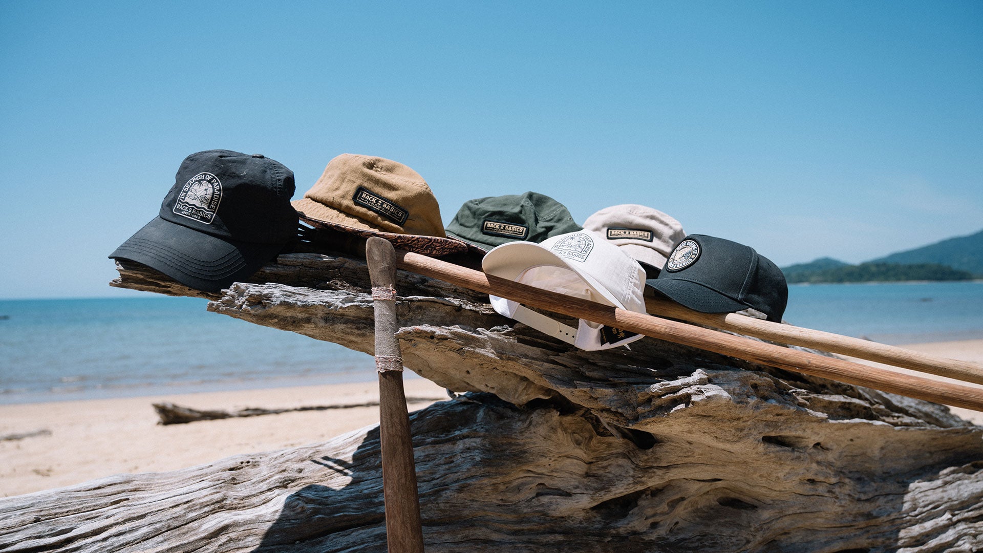 a variety of back 2 basics adventures hats, caps and bucket hats on the beach