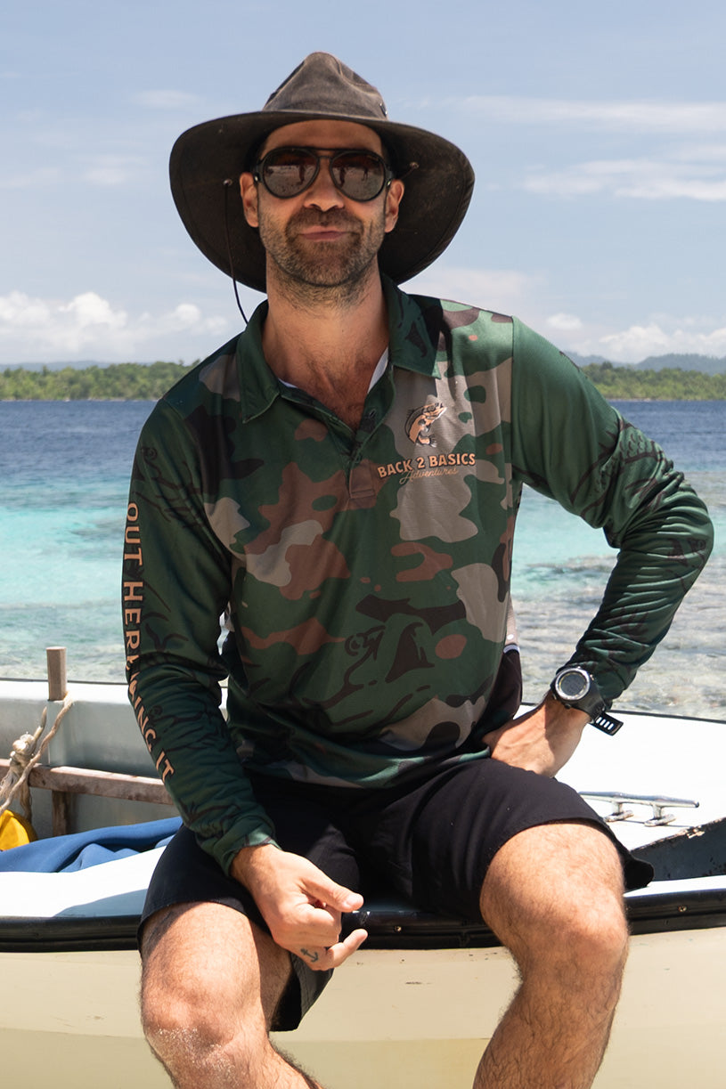 az from back 2 basics in a camo fishing jersey holding up a large yellow fin tuna caught on a fishing boat